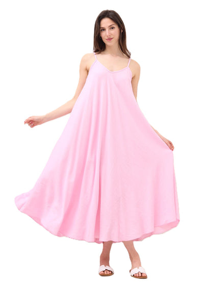 Woman wearing a pink sleevless maxi dress with spaghetti straps on a white background