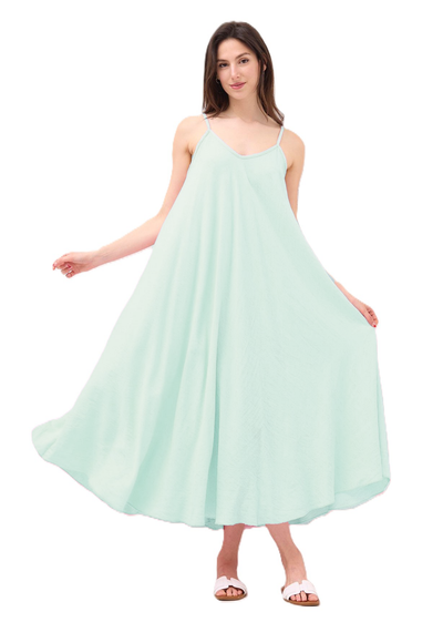 Woman wearing a light green dress on a white background