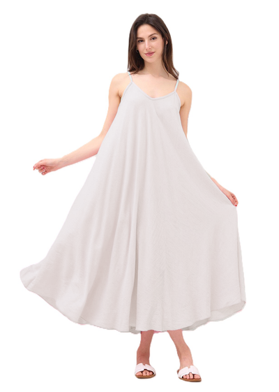 Woman wearing a cream coloured dress on a white background