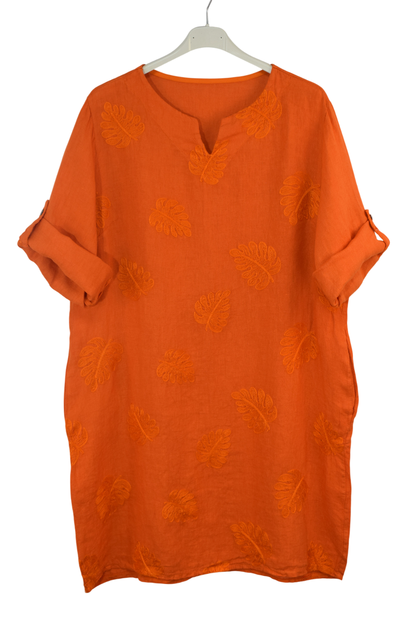 Orange dress with embroidered leaf  patterns on a white background