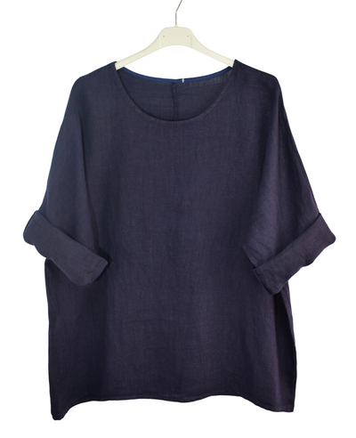 Navy blue shirt on a hanger against a white background