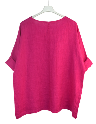 Pink blouse on a white hanger against a white background