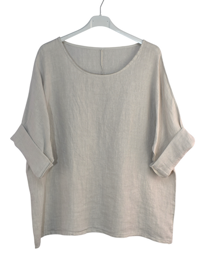 Beige oversized shirt on a hanger against a white background