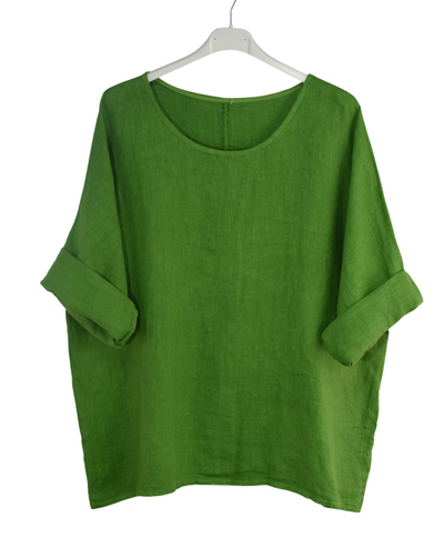 Green shirt on a white hanger with a white background