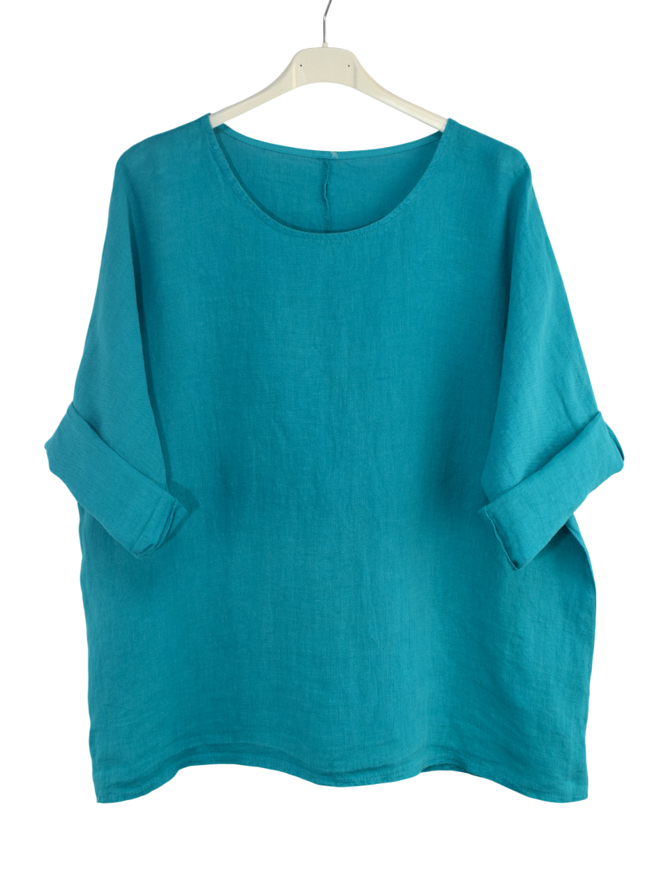 Teal oversized linen top on a hanger against a white background